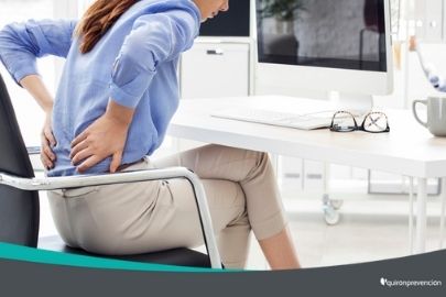 mujer sentada en escritorio con dolor de espalda imagen pequeña