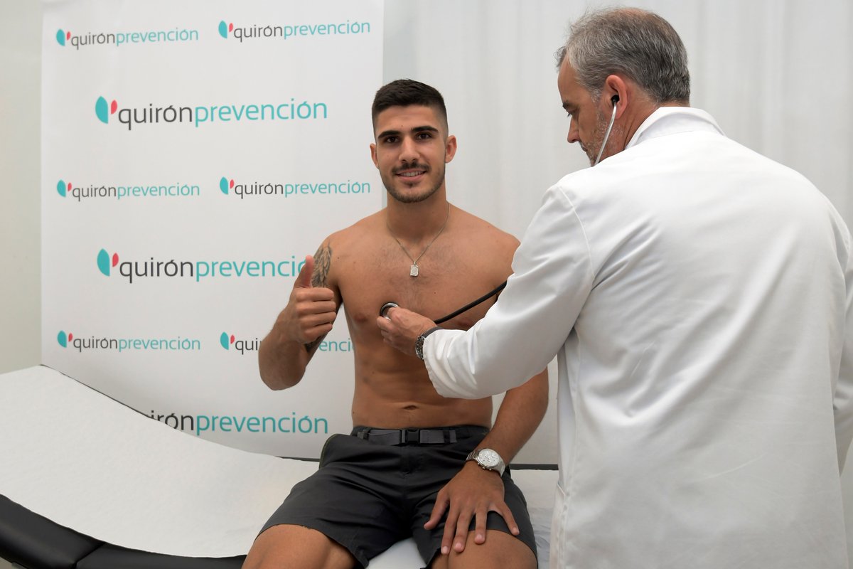 médico midiendo pulsaciones futbolista